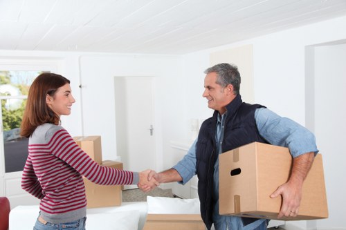 Packed moving boxes and furniture prepared for a Tokyngton relocation