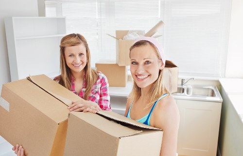 Professional movers handling furniture during a Tokyngton house removal